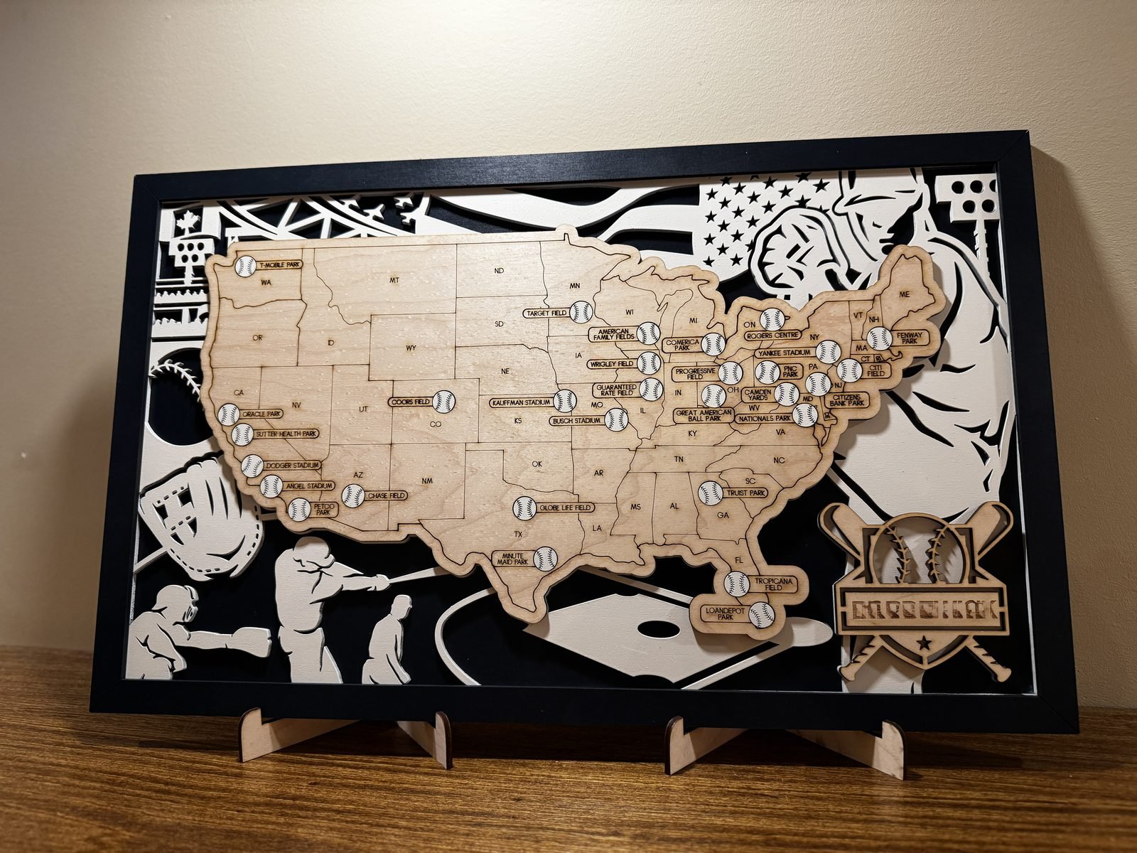 Detailed laser-cut baseball stadium travel map in a framed display