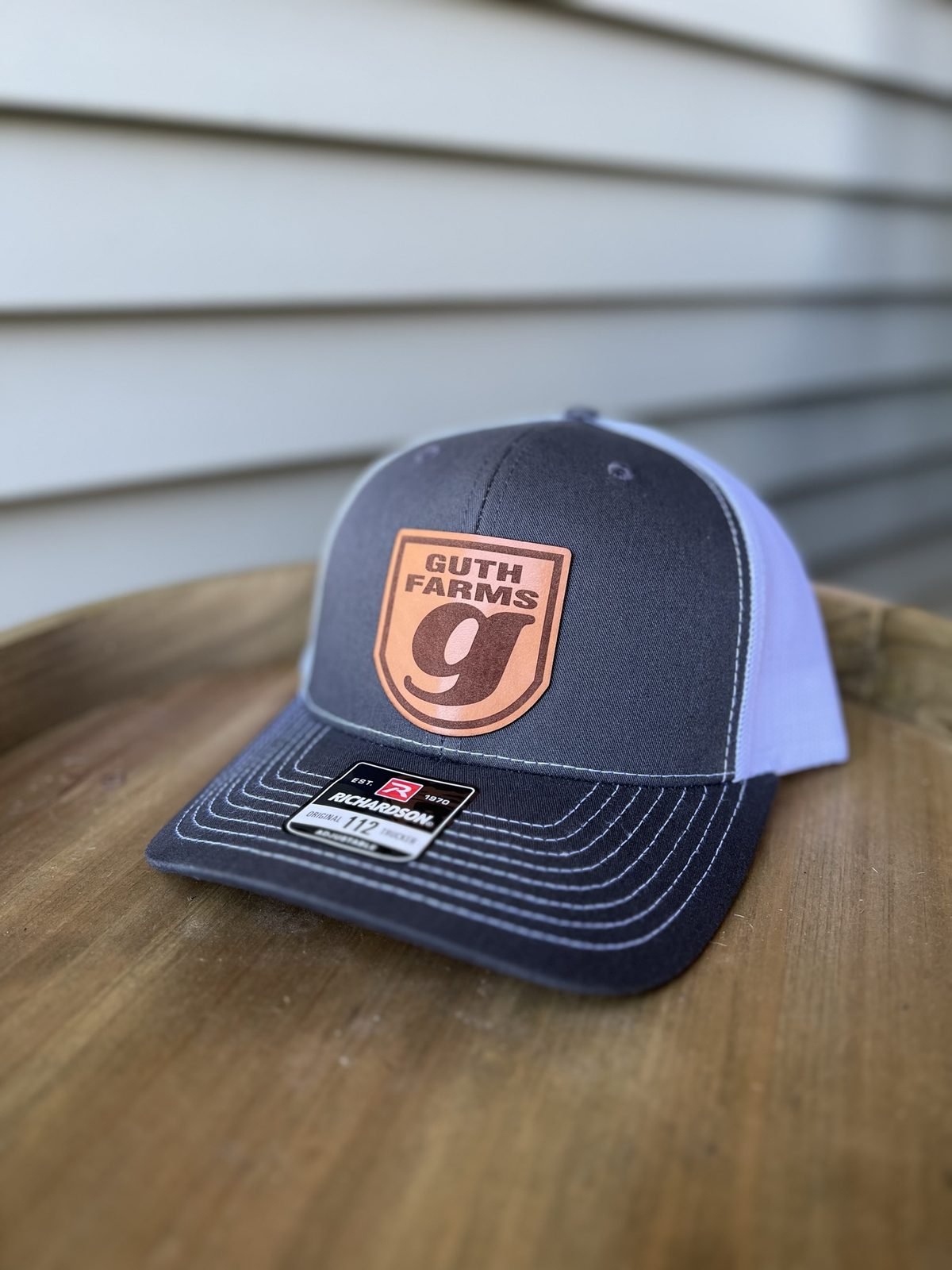 Navy and white trucker hat with custom Guth Farms leather patch